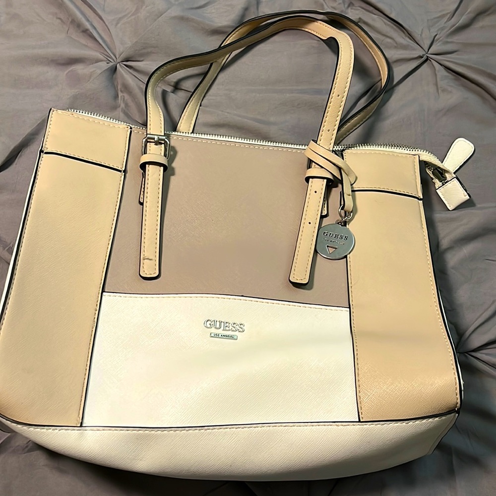 Nude color GUESS hand bag. Small marks on back of bag but only used once.